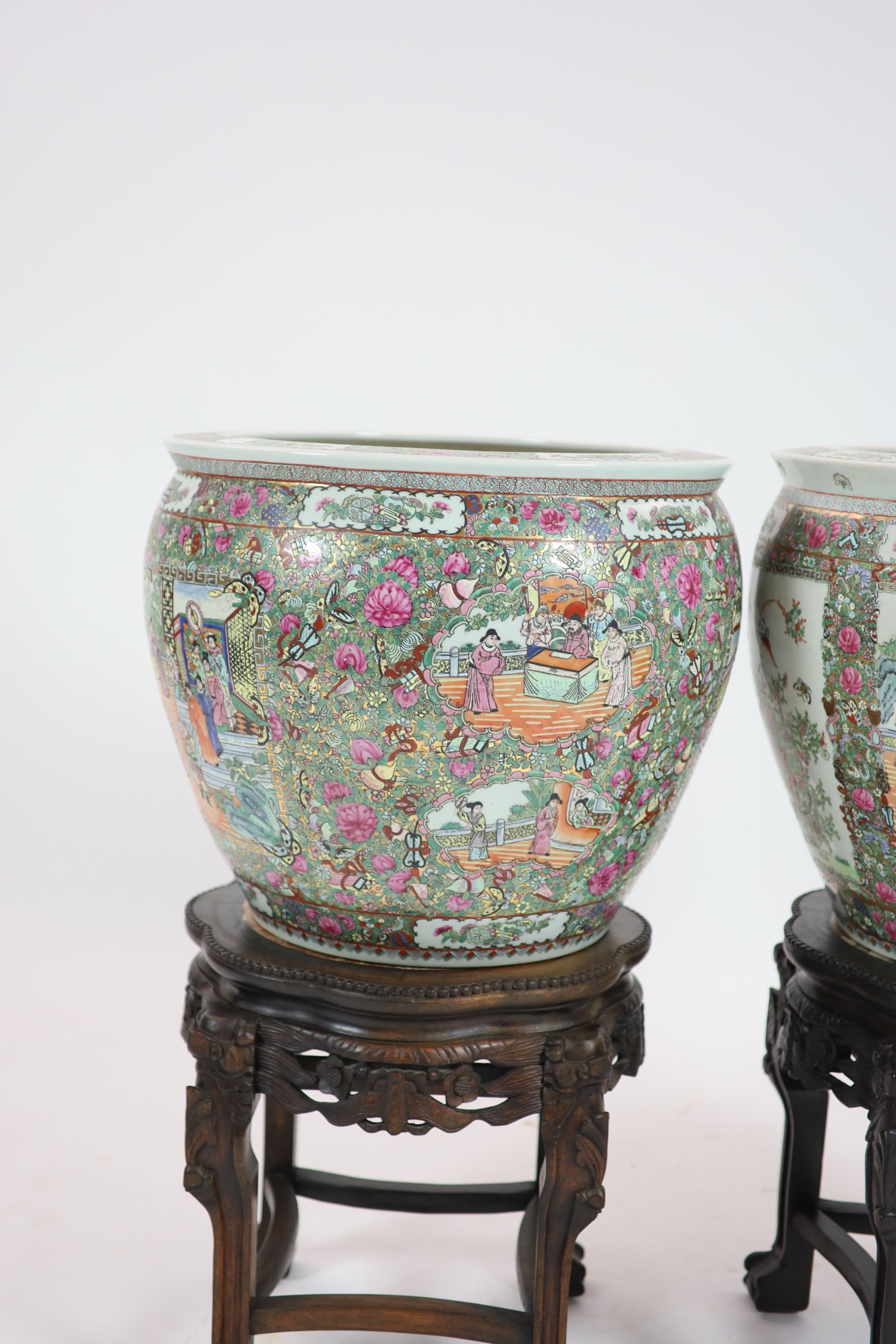 A pair of Chinese famille rose gold fish bowls, 56cm diameter with ebonised and marble inset stands, total height 91cm